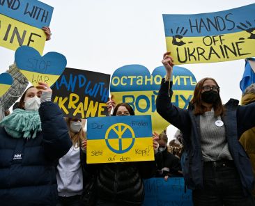 Supporters of the Fridays for Future movement hold up placards in the colors of Ukraine as they demonstrate against the war in Ukraine on Thursday, March 3, 2022 in Berlin. (Photo by John MACDOUGALL / AFP)