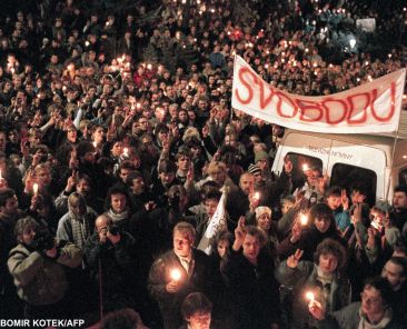 Thousands of people gather under a banner reading "Liberty" flashing Victory signs 17 November 1989 in Prague as they stage the biggest anti-Communist rally for 20 years in response to dissident movement Civic Forum's call demanding the end of Communist rule and free multiparty elections. The riot police later beat and arrested hundreds of demonstrators. A strong dissident protest movement led to the fall of communism 10 December and the formation of a non-Communist government in Czechoslovakia, 10 days after the beginning of a summit in Malta where Soviet President Mikhail Gorbachev and US counterpart George Bush set a new era, ending the Cold War. (Photo by LUBOMIR KOTEK / AFP)